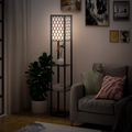 Shelf floor lamp lit in a living room corner beside an armchair