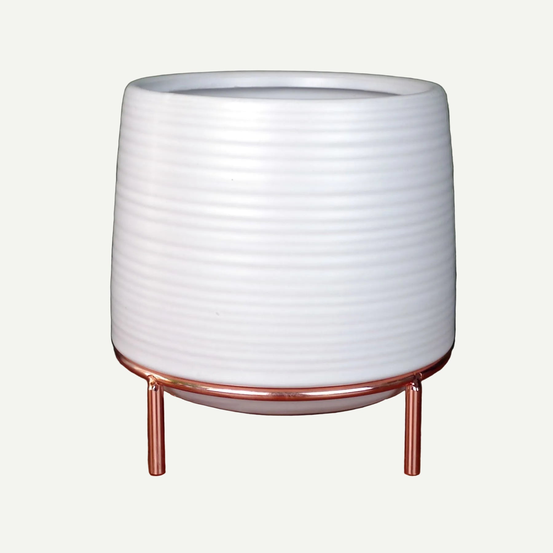 Ribbed white ceramic planter on slim copper legs